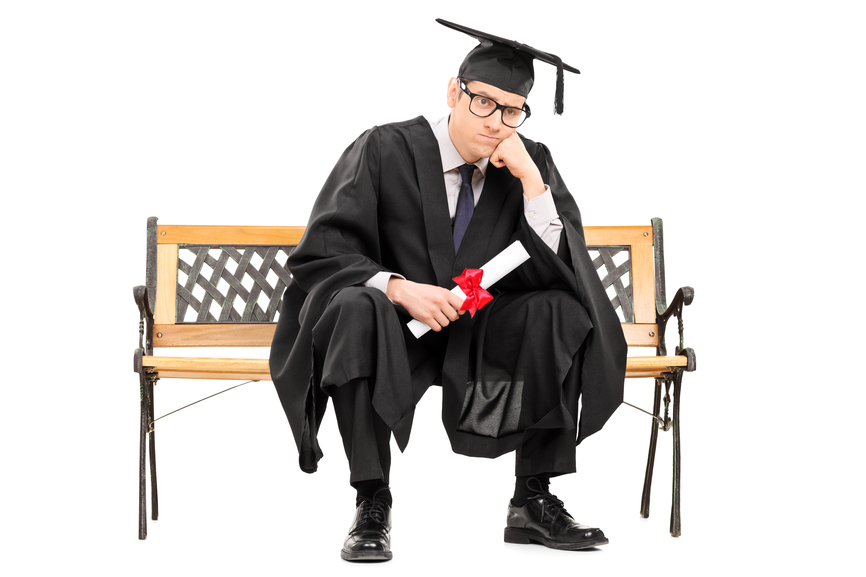 Angry college graduate holding a diploma isolated on white background